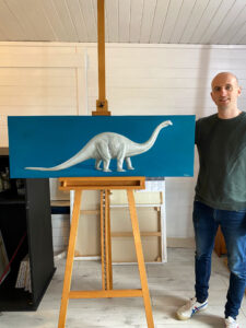 Gary Armer Artist in Studio with Bronto Painting