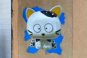 Detail of Toy Cat Painting on Board